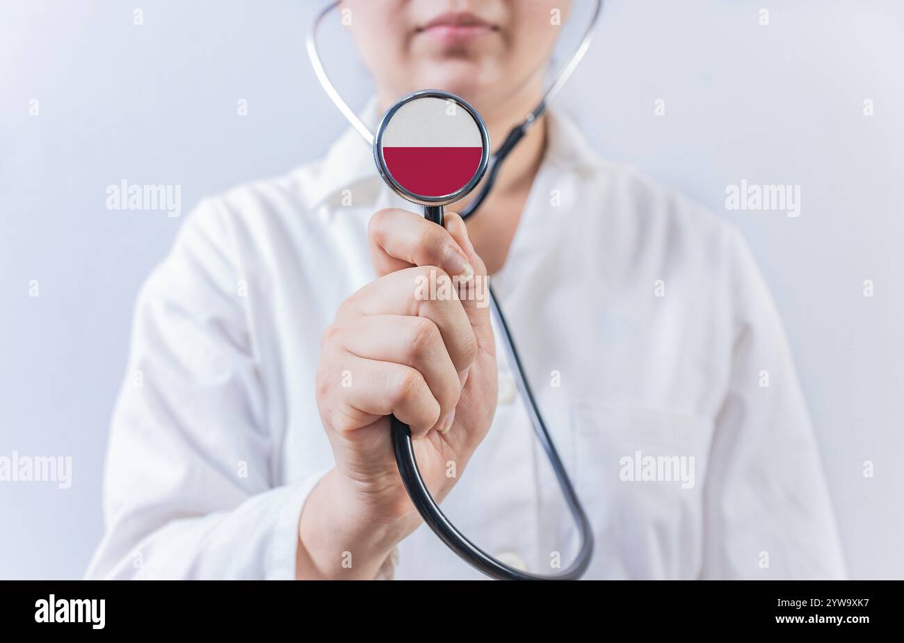Arzt hält Stethoskop mit polnischer Flagge. Nationales Gesundheitssystem Polens Stockfoto