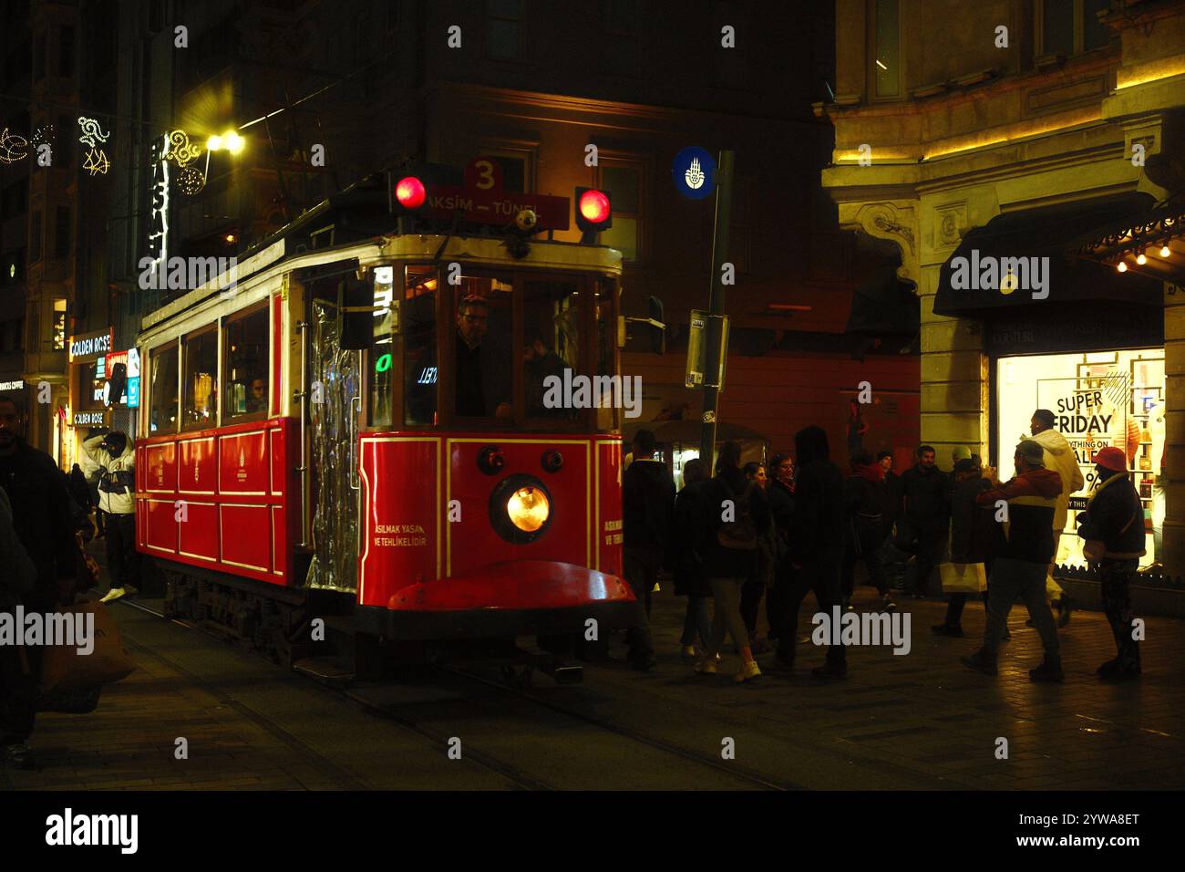 Beyoğlu, Istanbul, Türkei - 1. Dezember 2024: Nachtfotografie der roten Vintage-Straßenbahn auf der nostalgischen Istanbul-Straßenbahn durch die Istiklal-Straße Stockfoto