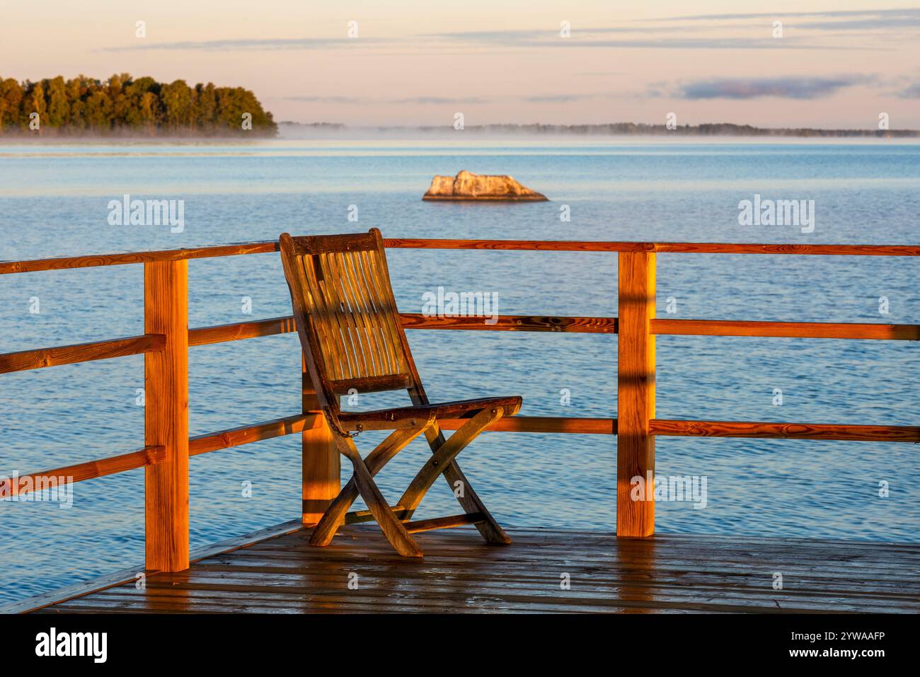 Ein Liegestuhl auf einem Steg neben dem See Hjälmaren, Schweden Stockfoto