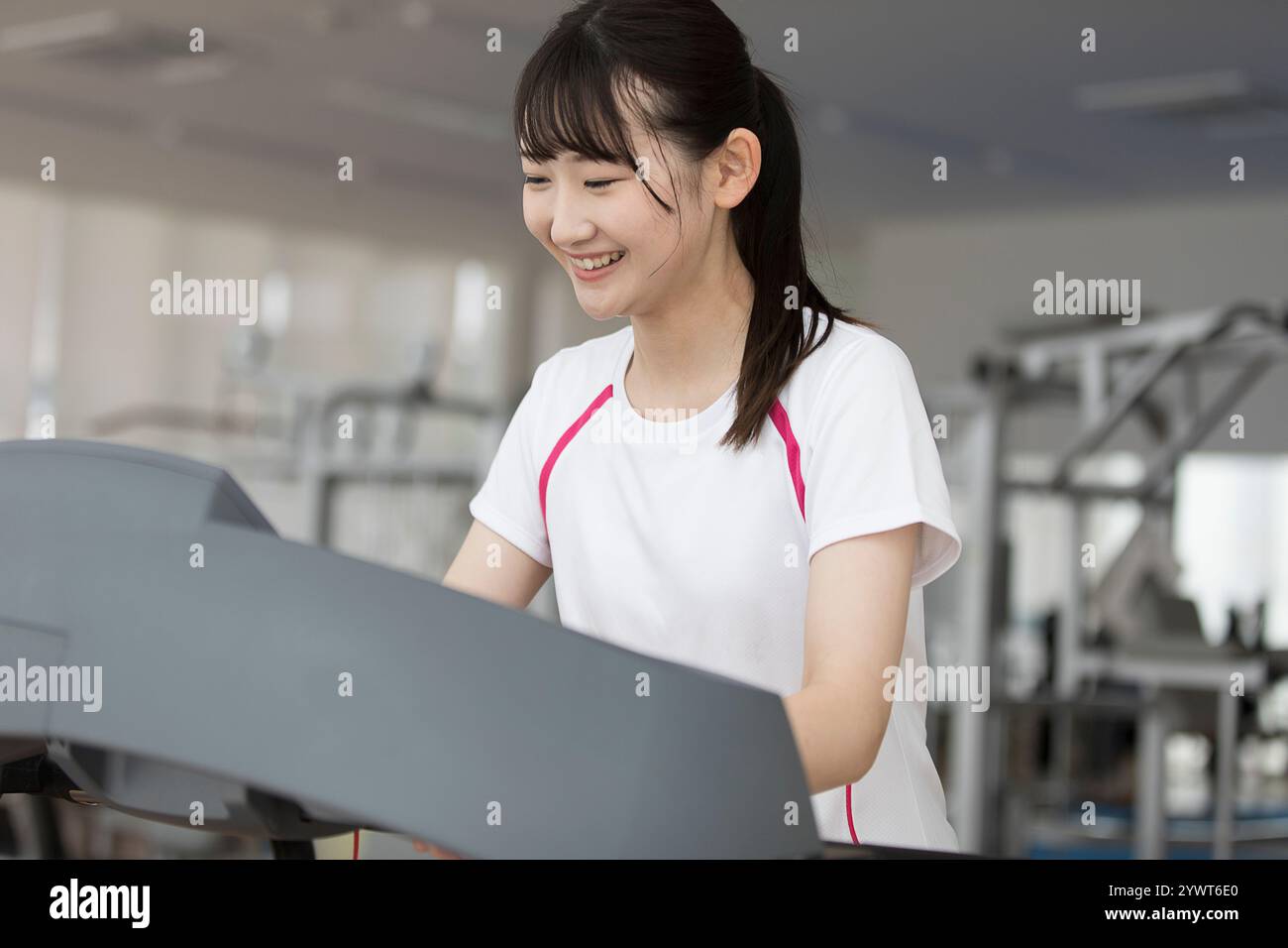Eine japanische Frau, die auf einer Laufmaschine läuft Stockfoto
