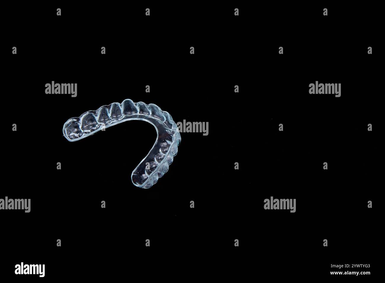 Ein klarer Mundschutz auf dunklem schwarzem Hintergrund, geeignet für Makroaufnahmen, um die komplizierten Details und das einzigartige Design hervorzuheben Stockfoto