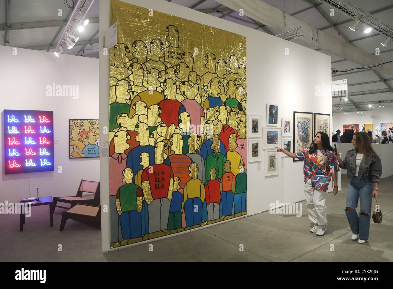 MIAMI, FLORIDA - 5. DEZEMBER: Gemälde von stilisierten Figuren aus Acryl auf Wärmebüchern mit dem Titel Crowd (2023) von Fabrizio Dusi präsentiert von Mazzucchelli Art Consulting auf der Context Art Miami im Rahmen der Miami Art Week am 5. Dezember 2024 in Miami, Florida. (Foto: Sean Drakes/Alamy) Stockfoto