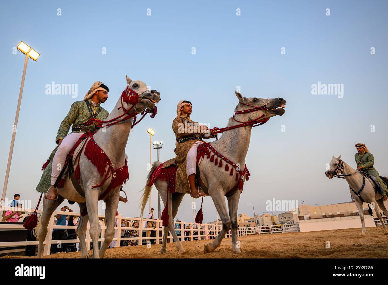 DOHA, KATAR - 13. Dezember 2024: Männer reiten auf Pferden, um den katarischen Nationalfeiertag zu feiern. Stockfoto