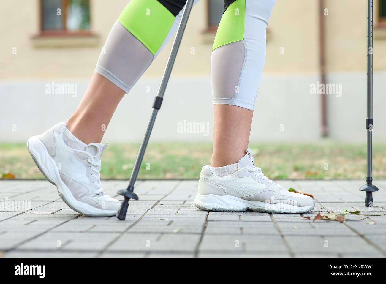 Sportliche Frau, die Nordic Walking auf der Straße macht, Nahaufnahme Stockfoto