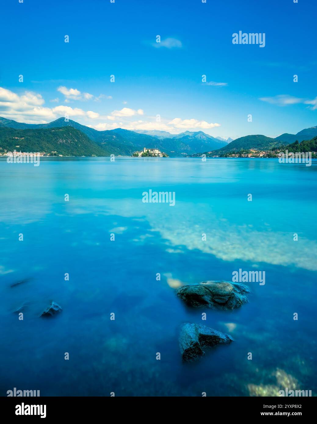 Landschaft des Lake Orta. Felsen und Julius Island, Isola San Giulio auf italienisch, im Hintergrund. Aufnahmen mit langer Belichtung. Provinz Novara. Piemont Stockfoto