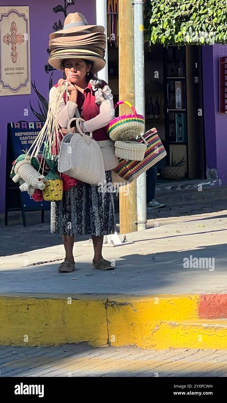 Eine ältere Frau verkauft Hüte und Taschen in Oaxaca City, Mexiko. Stockfoto