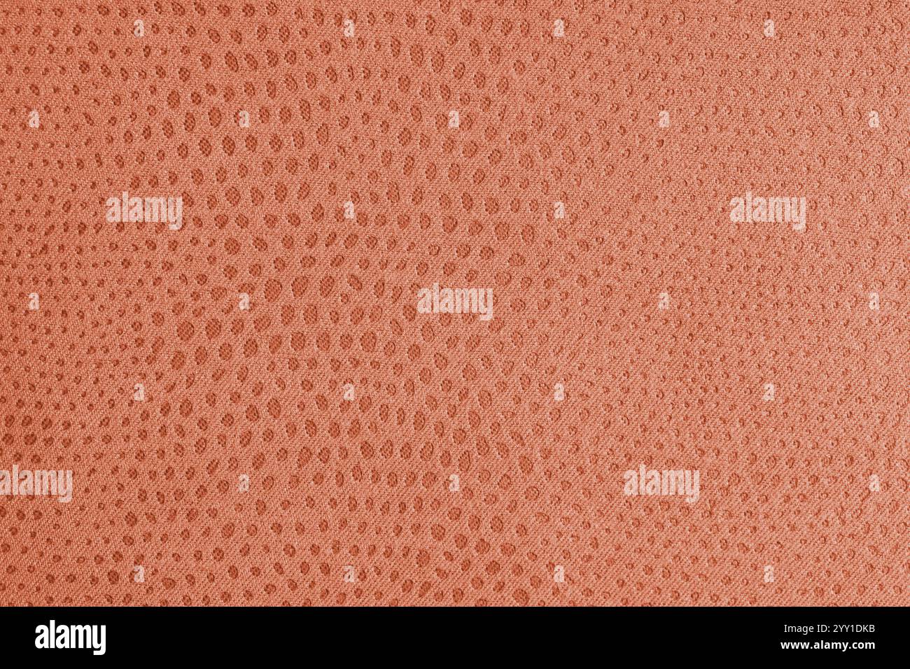 Tuchstruktur aus orangefarbenem Jacquard-Stoff mit abstrakter Shabby-Punktprägung, Textur-Nahaufnahme, Makro. Polsterung, dekorative Stoffstruktur, Heim Stockfoto