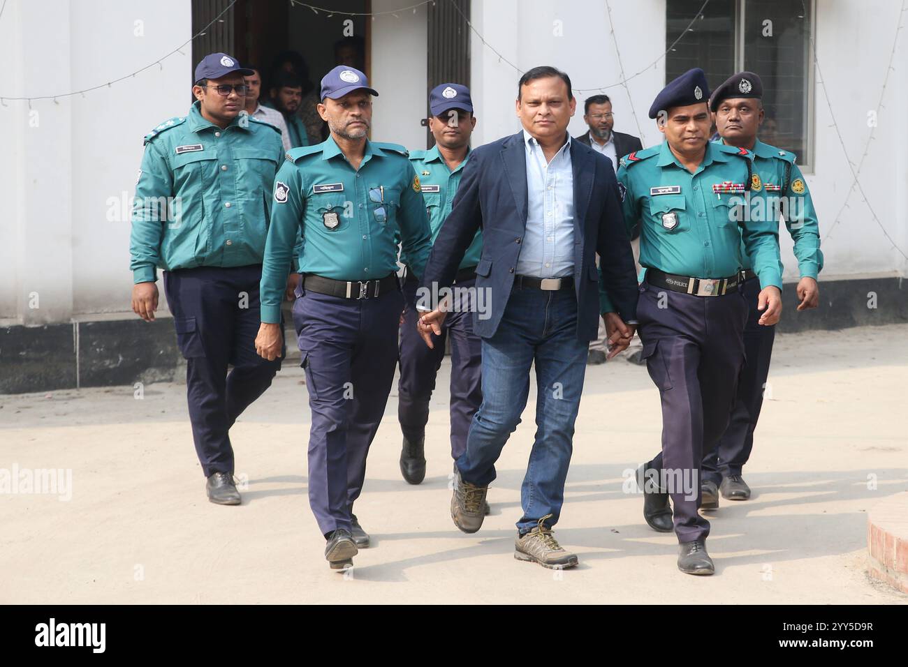 Dhaka, Wari, Bangladesch. Dezember 2024. Polizeipersonal eskortiert den Gefangenen Ziaul Ahsan, ehemaliger Militärgeneral und ehemaliger Generaldirektor des Nationalen Telekommunikationsüberwachungszentrums (NTMC), am 19. Dezember 2024 zum Gericht des Internationalen Strafgerichtshofs für Verbrechen in Bangladesch in Dhaka. 13 ehemalige, nach der Revolution im August verhaftete Regierungsbeamte Bangladeschs erschienen am 18. November vor Gericht, die der Ermöglichung von Massakern beschuldigt wurden. Die Staatsanwälte wiederholten Auslieferungsanträge für den Ex-Exilführer Scheich Hasina. Dutzende ihrer Verbündeten wurden seit der Regie in Gewahrsam genommen Stockfoto