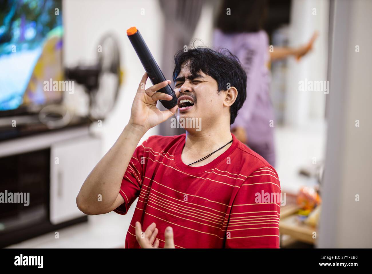 Energischer Performer mit Mikrofon. Melancholischer Sänger, Der Tiefe Emotionen Ausdrückt. Stockfoto