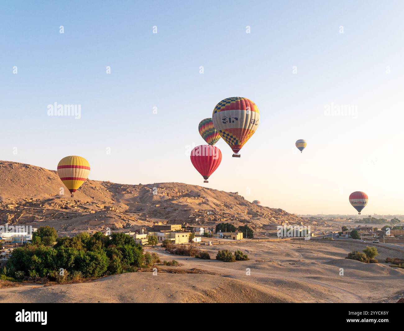 Heißluftballons fliegen über das Tal der Könige, Luxor, Ägypten vor dem Himmel und der Hügellandschaft - Landschaftsaufnahme Stockfoto