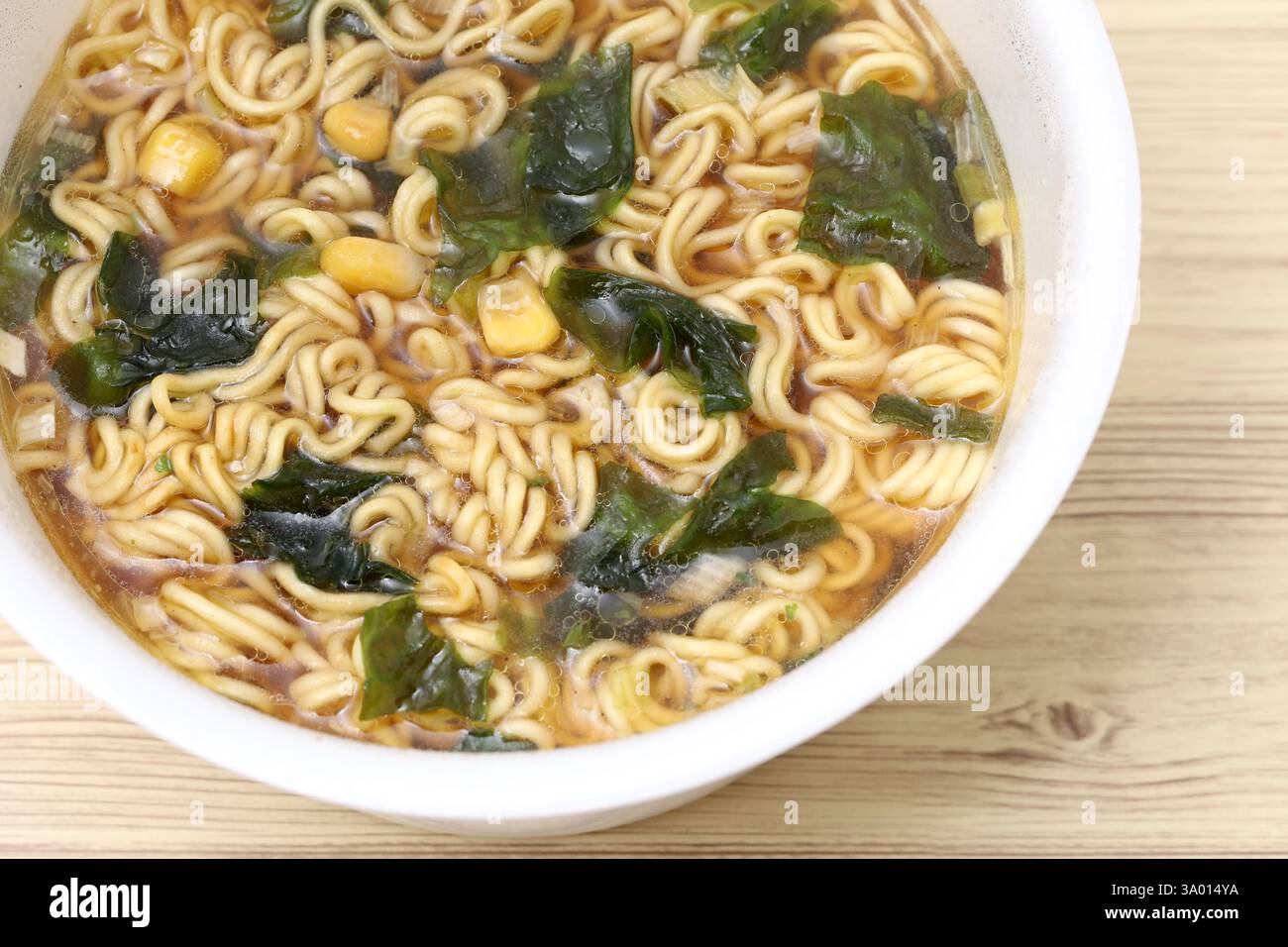 Gekochte Instant-Nudeln in einer Tasse auf Tischhintergrund Stockfoto