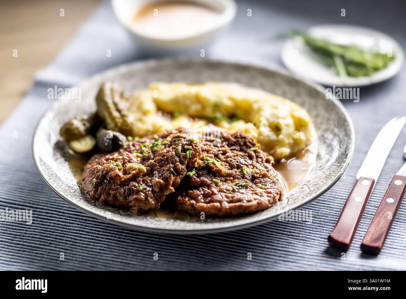 Inverted Beef Schnitzel mit Kartoffelpüree und eingelegten Gurken. Traditionelle tschechische und slowakische Küche Stockfoto