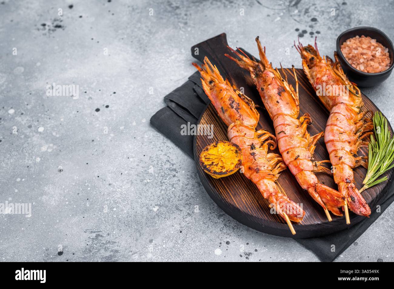 Fischspieße mit gegrillten roten argentinischen Garnelen, Garnelen Langostino Austral. Grauer Hintergrund. Draufsicht. Stockfoto