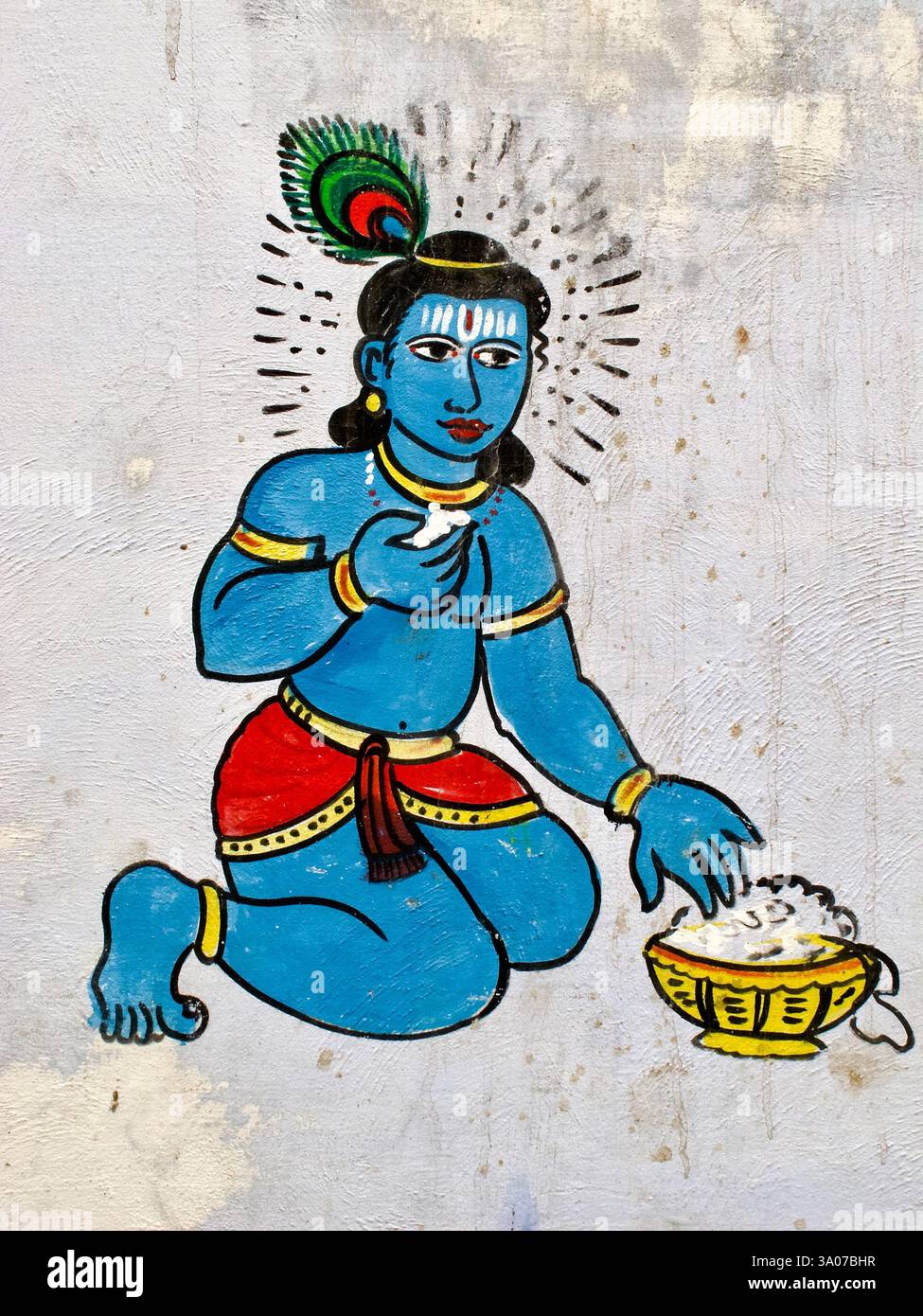 Wandgemälde von Bala Krishna in Varanasi, Indien, das die Kindgottheit beim Butteressen zeigt, ein beliebtes hinduistisches Motiv, das göttliche Verspieltheit und Hingabe symbolisiert. Stockfoto