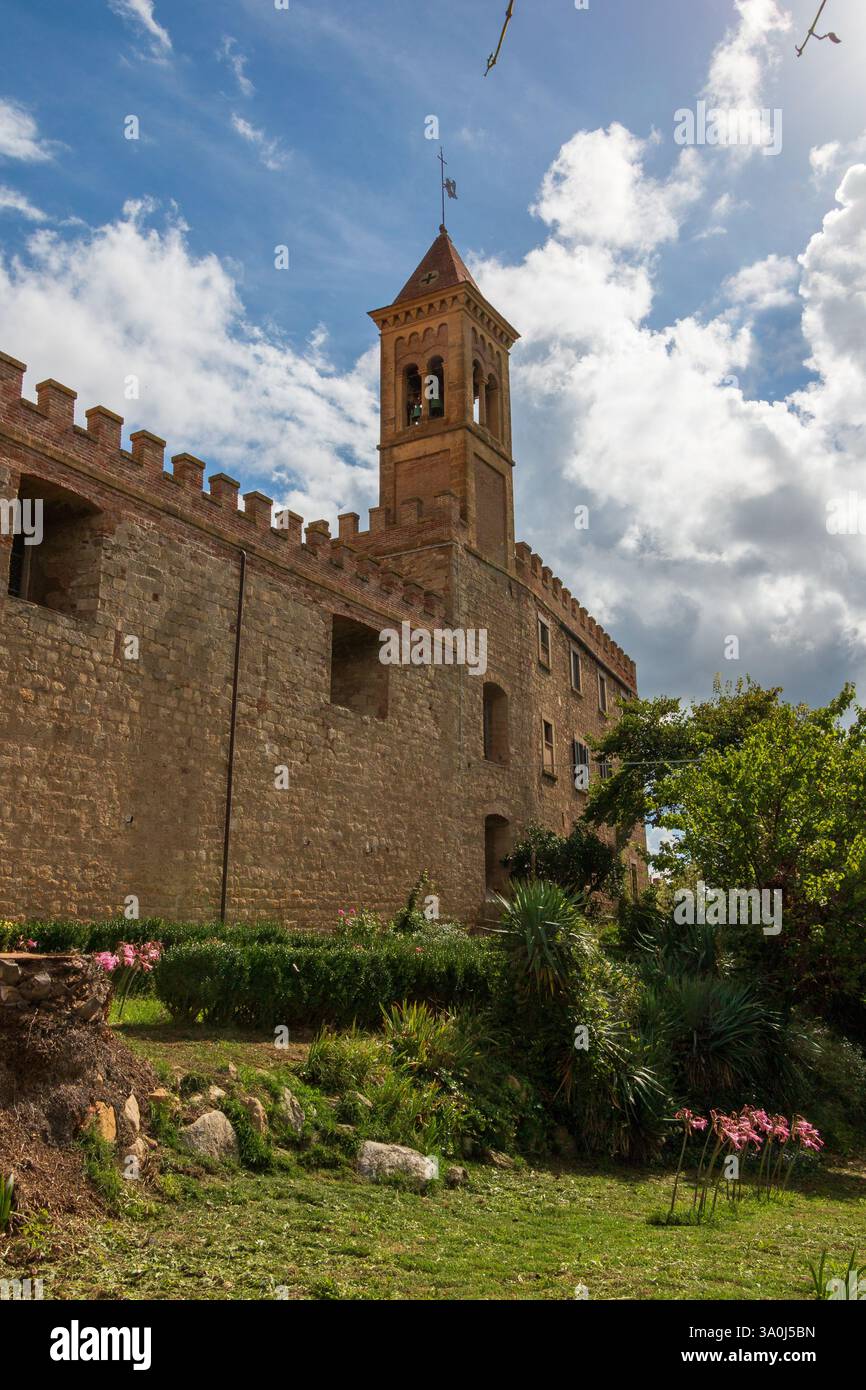 Die umliegende Mauer und der Glockenturm der kleinen Kirche des berühmten mittelalterlichen Dorfes Bolgheri in der Toskana. Stockfoto