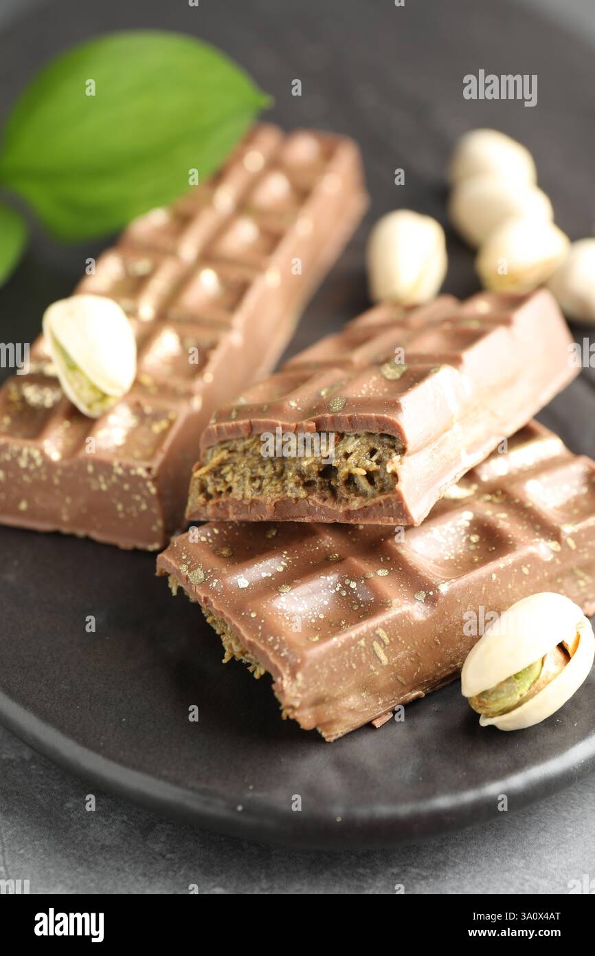 Köstliche Dubai Schokoladenriegel und Pistazien auf dem Tisch, Nahaufnahme Stockfoto