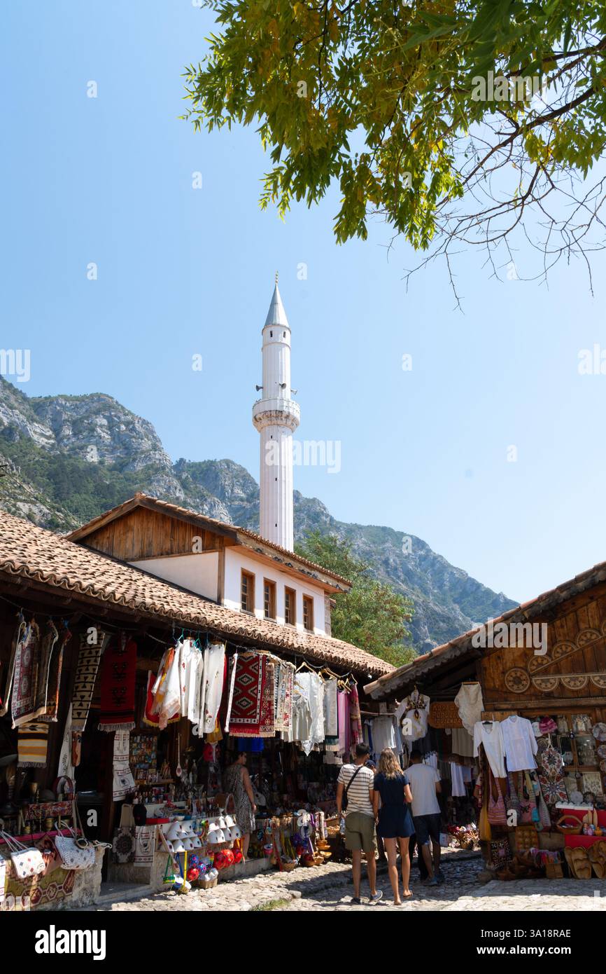 Kruja, Albanien - 13. August 2024: Traditioneller Basar mit Moschee-Minarett Stockfoto