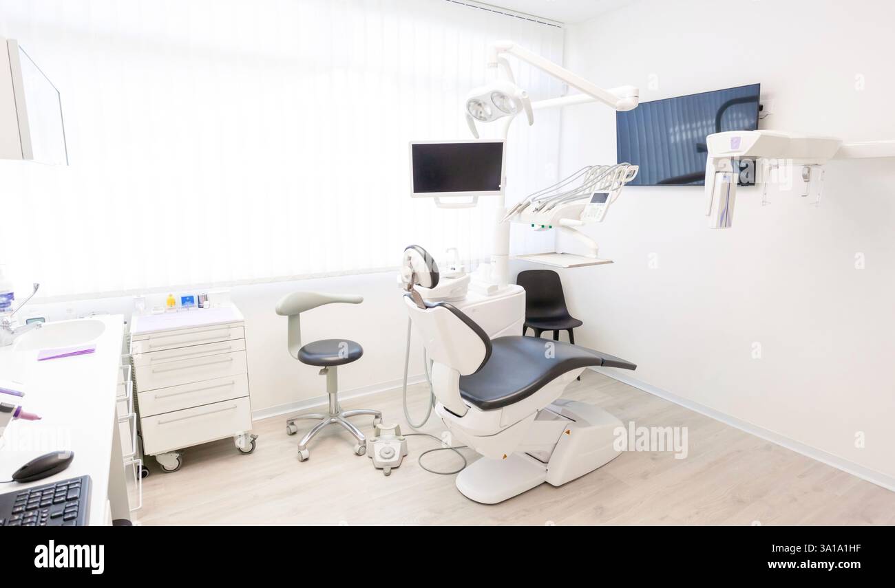 Leere Zahnklinik mit moderner Ausstattung, einschließlich eines Zahnarztstuhls, Monitors und anderer Werkzeuge, die für Patienten bereit sind Stockfoto