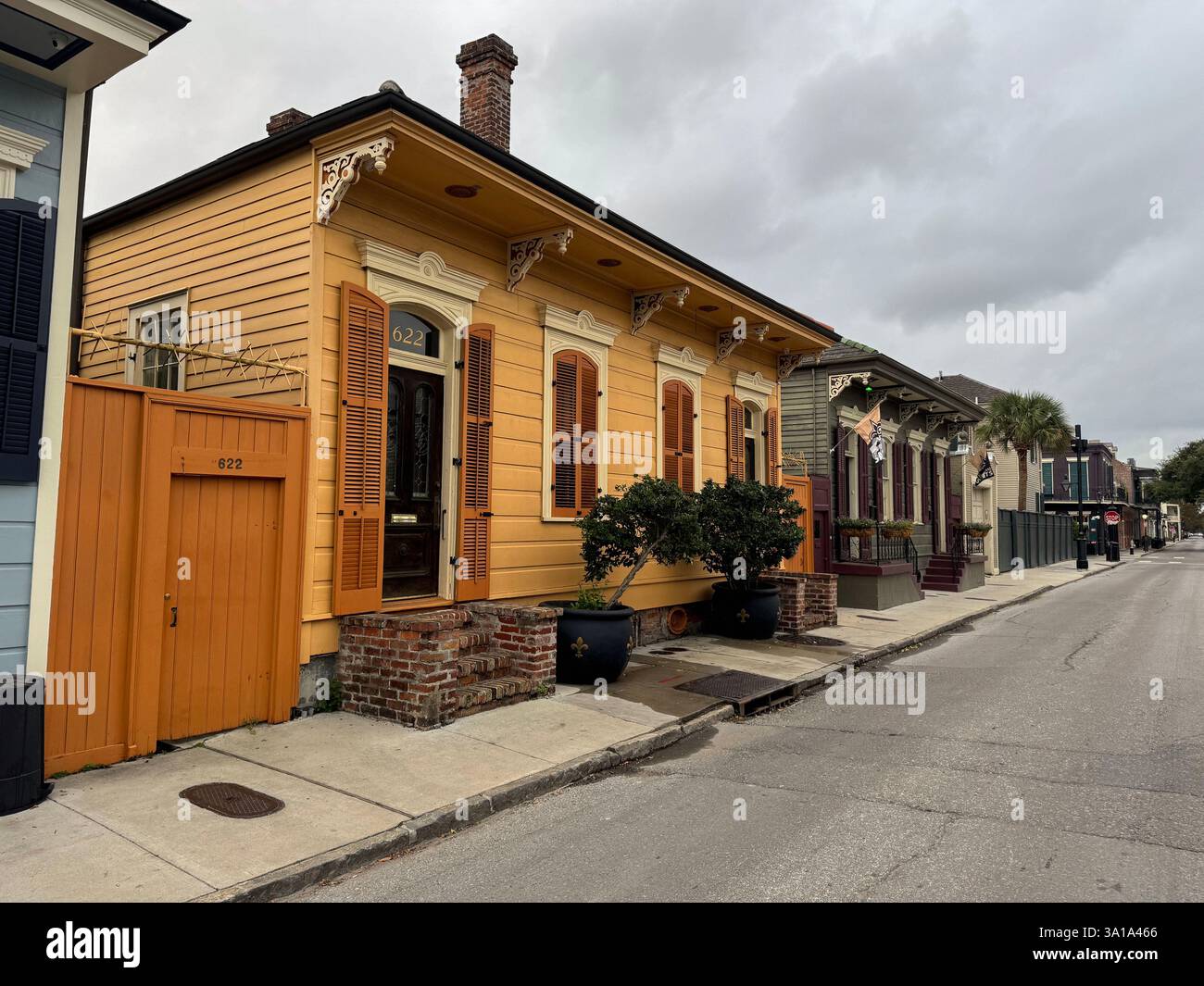 Klassisches Schrotflintenhaus in New Orleans mit ähnlichen Häusern nebenan und die Straße runter. Stockfoto