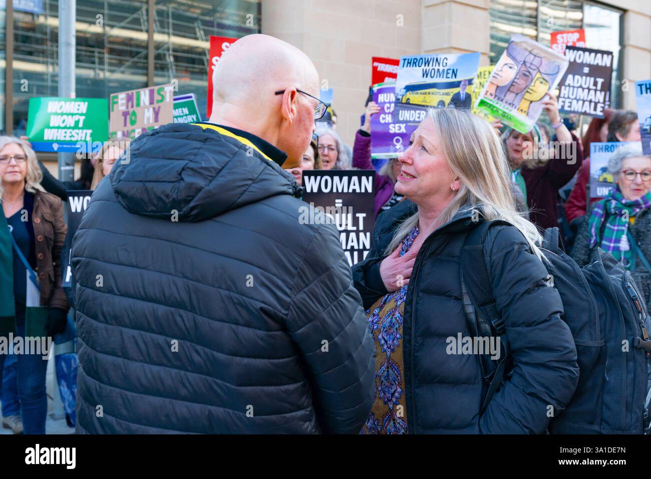 Edinburgh, Schottland, Großbritannien. März 2025. Die Frauenpro-Frauengruppe Schottland veranstaltete vor dem Veranstaltungsort des Internationalen Frauentags der SNP in Edinburgh eine Proteste, an der die Referenten First Minister John Swinney und die ehemalige First Ministerin Nicola Sturgeon teilnahmen. Die Demonstranten sind unglücklich darüber, dass die SNP keinen Unterschied zwischen Transsexuellen und Frauen macht und welche Auswirkungen diese Politik auf die rein weiblichen Räume hat. Herr Swinney sprach mit Marion Calder, Direktorin für Frauen Schottland, bevor er an der Veranstaltung teilnahm. John Swinney spricht mit Marion Calder. Iain Masterton/Alamy Live News. Stockfoto