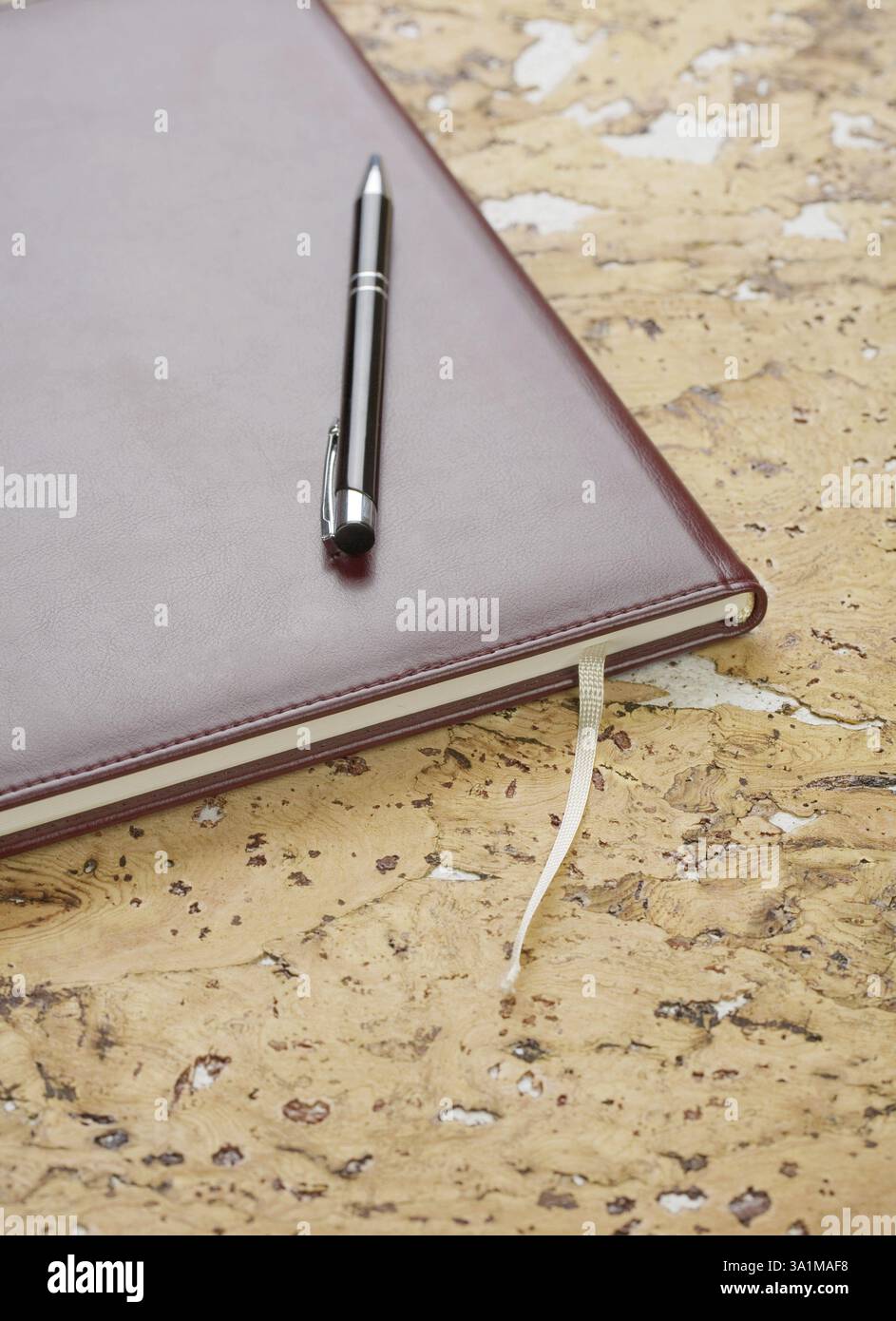 Stift und Tagebuch auf Korkholz Stockfoto