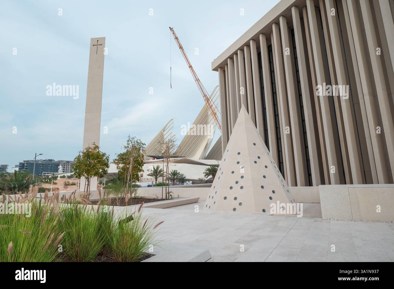 Abu Dhabi, Vereinigte Arabische Emirate - 23. Februar 2025: Das Haus der Abrahamic-Familie mit dem Zayed-Nationalmuseum im Hintergrund Abu Dhabi, VAE, steht als Stockfoto