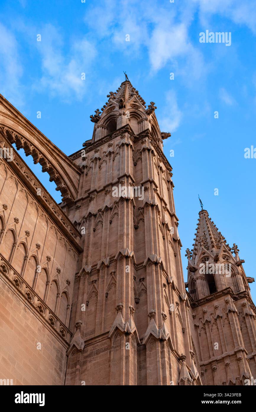 Die Türme der Kathedrale von Palma de Mallorca erheben sich vor einem klaren blauen Himmel in Spanien und zeigen atemberaubende gotische Architektur Stockfoto