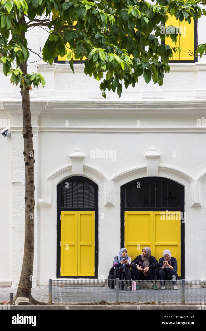 Frau, die vor dem Gebäude sitzt, Chinatown, Kuala Lumpur, Selangor, Malaysia Stockfoto