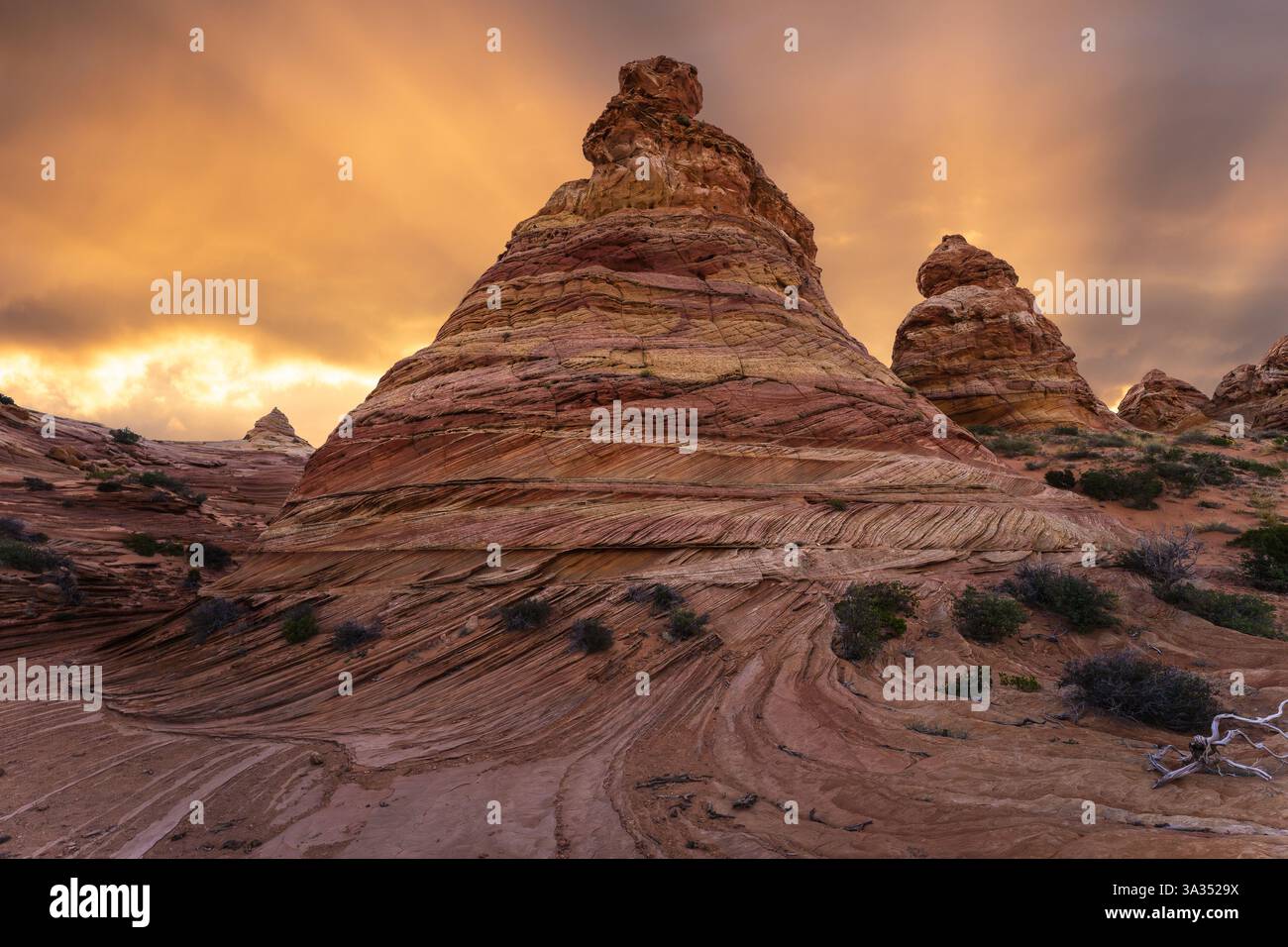 Der lebhafte Sonnenuntergang beleuchtet die wirbelnden Sandsteinformationen der Coyote Buttes in der Paria Canyon-Vermilion Cliffs Wilderness, Arizona, und hebt den Himmel hervor Stockfoto