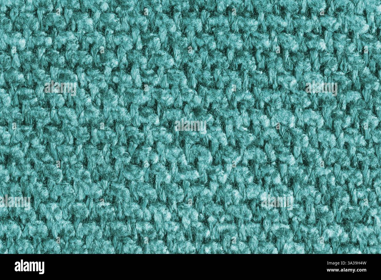 Textur aus türkisfarbenem Jacquard-Gewebe, Nahaufnahme eines Makros aus rauem Gewebe. Material für Heimtextilien, Polster und Vorhangdekor, Bekleidung. Hintergrund, wal Stockfoto