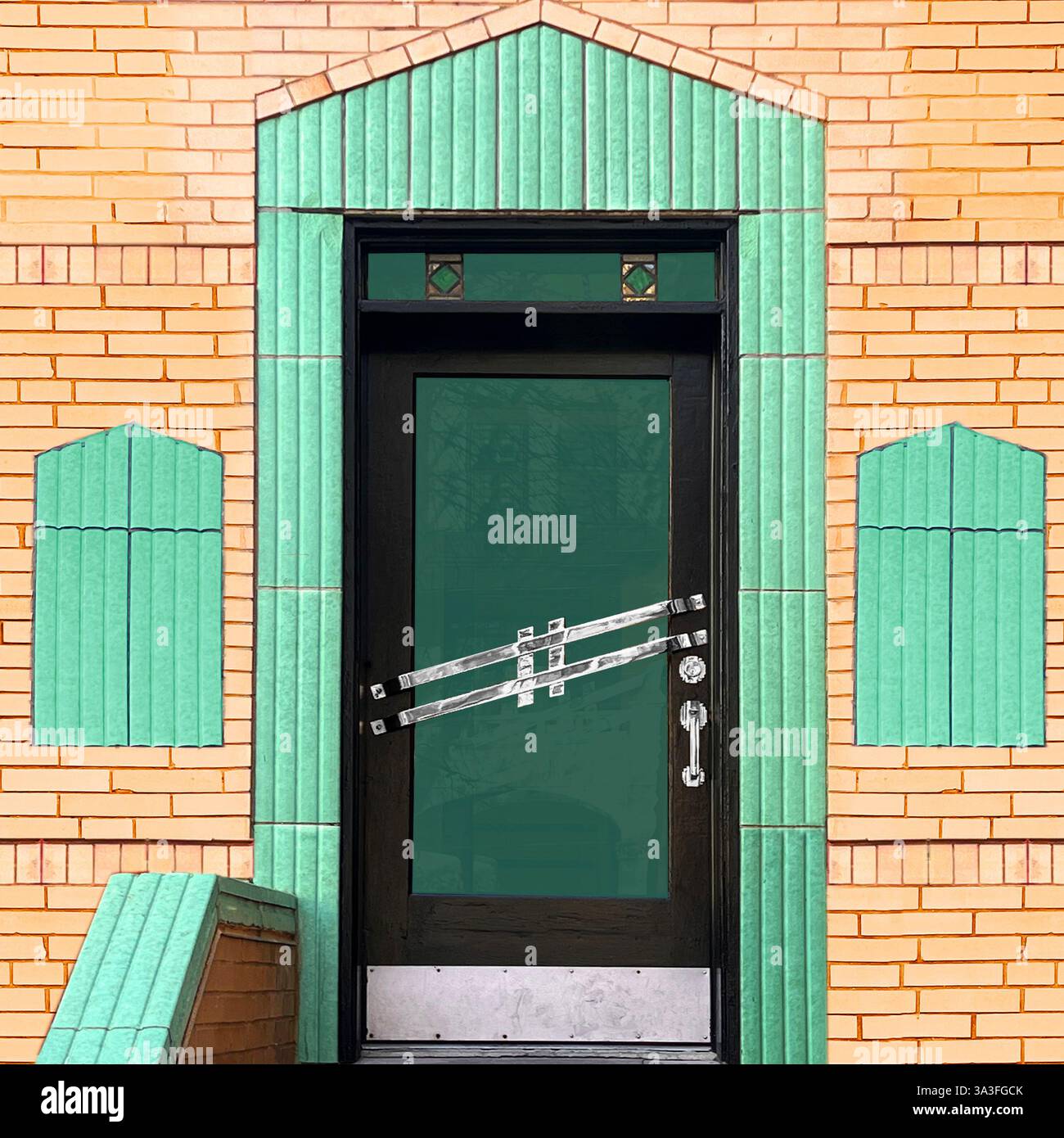 Art déco-Eingang mit einer eleganten Glastür, die von leuchtenden mintgrünen Keramikfliesen und dekorativen Ziegelsteinen eingerahmt wird. Stockfoto Art déco-Eingang mit einer eleganten Glastür, die von leuchtenden mintgrünen Keramikfliesen und dekorativen Ziegelsteinen eingerahmt wird. Stockfoto