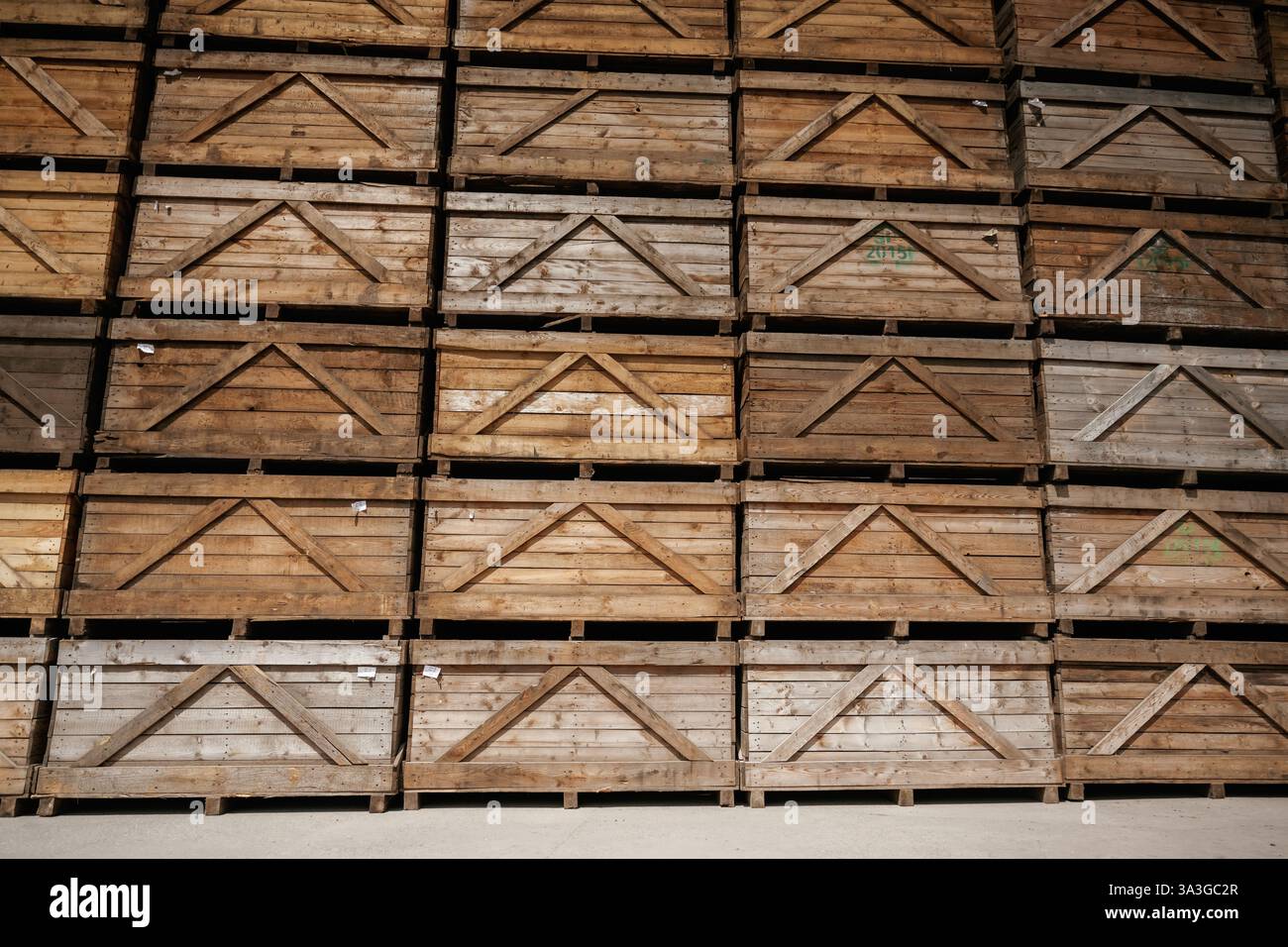 Gestapelte Holzkisten in einem organisierten Lager. Stockfoto