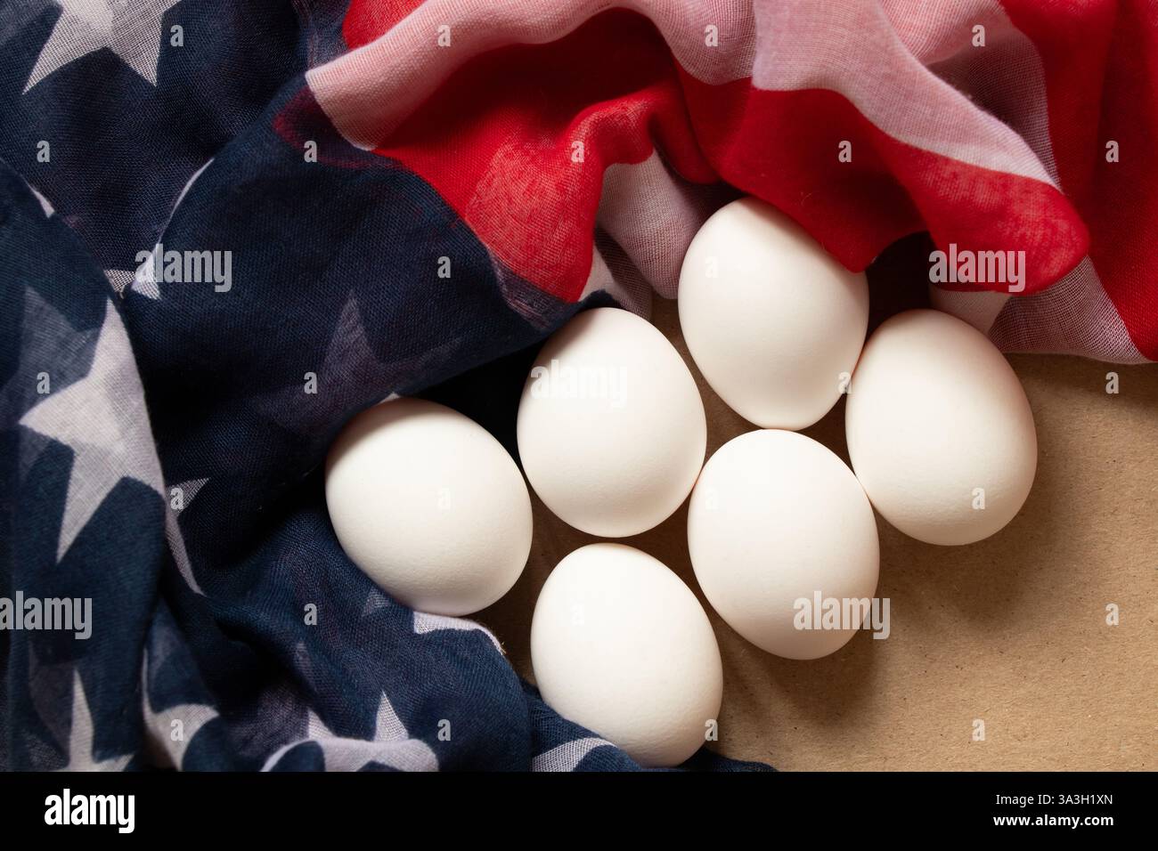 Hühnereier liegen auf der amerikanischen Flagge auf dem Küchentisch, Eiermangel in Amerika Stockfoto