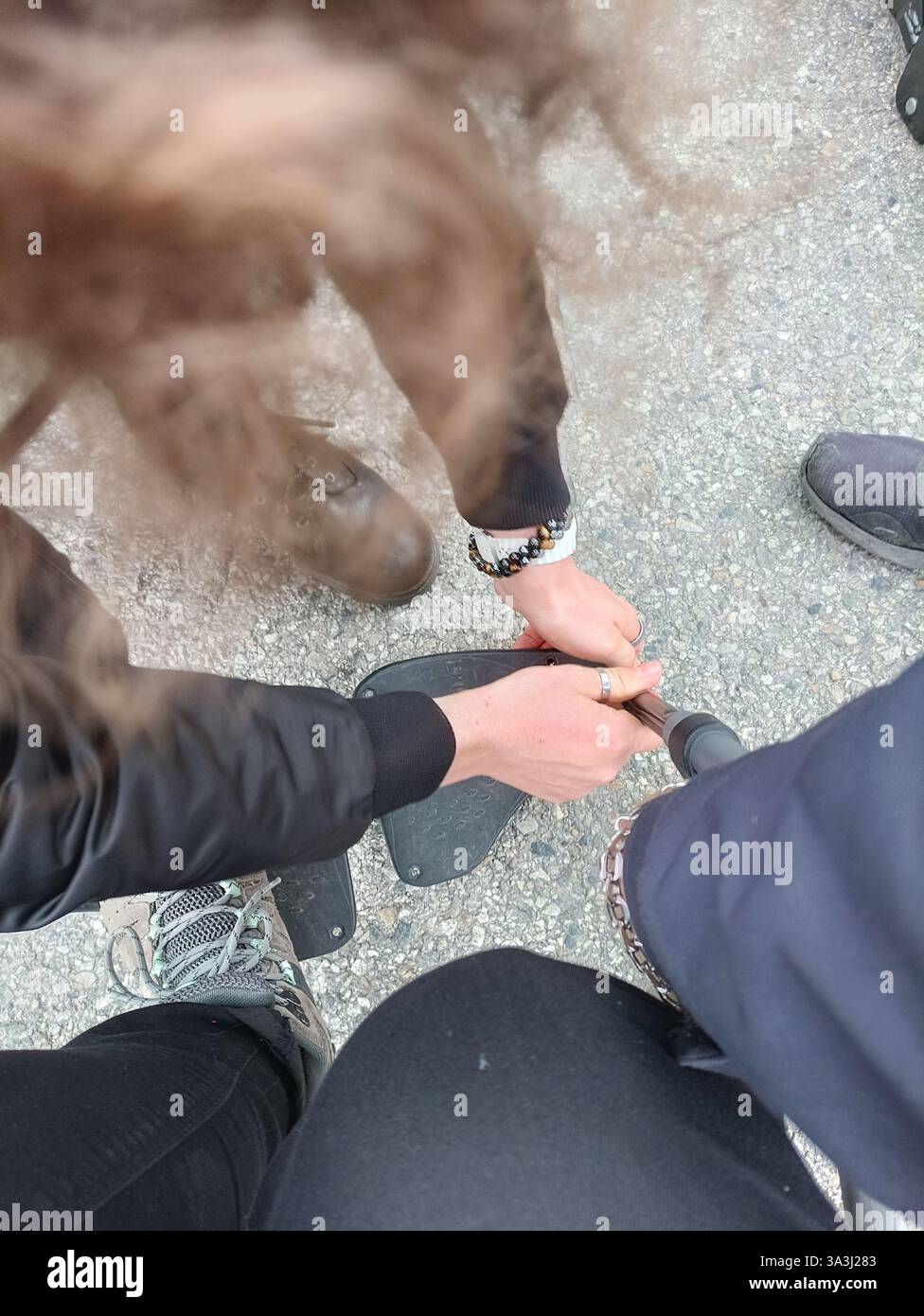 Frankreich : une personne aide une personne à mobilité reduite à réparer le repose pieds déboité Stockfoto
