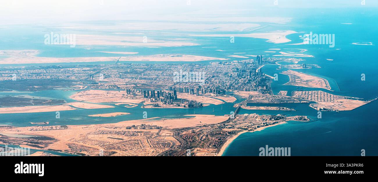 Atemberaubende Aussicht auf Abu Dhabi aus der Vogelperspektive mit modernen Wolkenkratzern, türkisfarbenem Meer und riesiger Wüstenlandschaft, die einen fesselnden Kontrast schaffen Stockfoto
