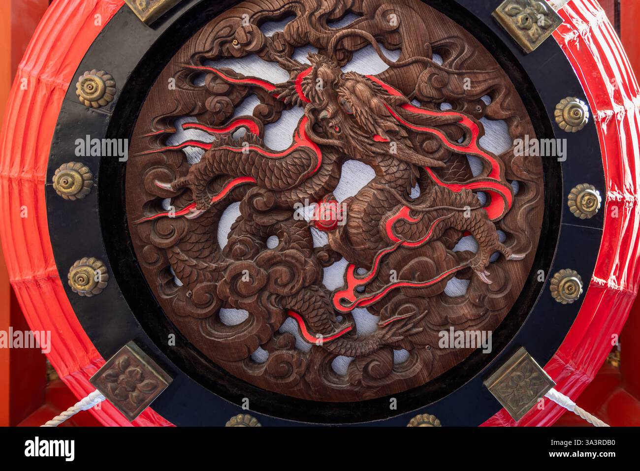 Detaillierte Holzschnitzereien eines Drachen schmücken die Unterseite einer riesigen Tempellaterne im Senso-JI-Tempel in Tokio und zeigen komplexe Handwerkskunst Stockfoto