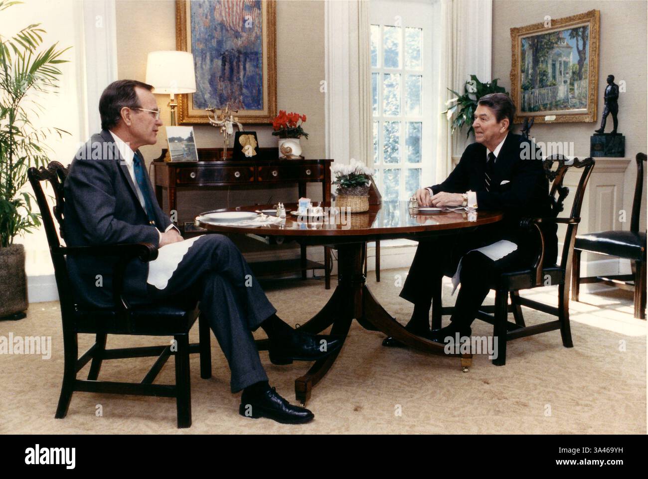 Februar 1988 - Washington, District of Columbia, Vereinigte Staaten von Amerika - Washington, D.C. - 10. Februar 1988 -- Präsident Ronald Reagan spricht mit Vizepräsident George H.W. Bush beim Mittagessen am 10. Februar 1988 in der Oval Office Study im Weißen Haus in Washington, D.C. Credit: White House via CNP (Credit Image: © White House/CNP/ZUMAPRESS.com) Stockfoto