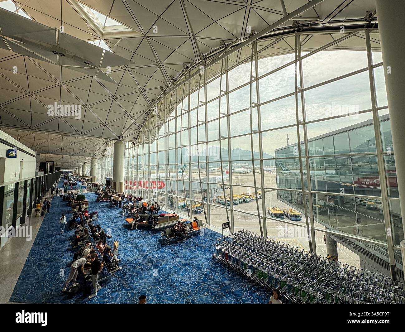 Innenraum des Flughafenterminals mit Blick auf den Asphalt am Hong Kong International Airport. Reise- und Transportkonzept. Stockfoto