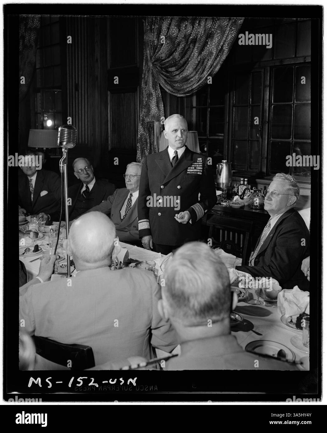 Konteradmiral Joel T. Boone spricht im Radio bei einem Mittagessen in Morgantown, West Virginia, bei dem örtliche Minenbetreiber und gewerkschaftsvertreter anwesend sind. Die Veranstaltung spiegelt die Zusammenarbeit zwischen Militär und Bergbau wider. Stockfoto