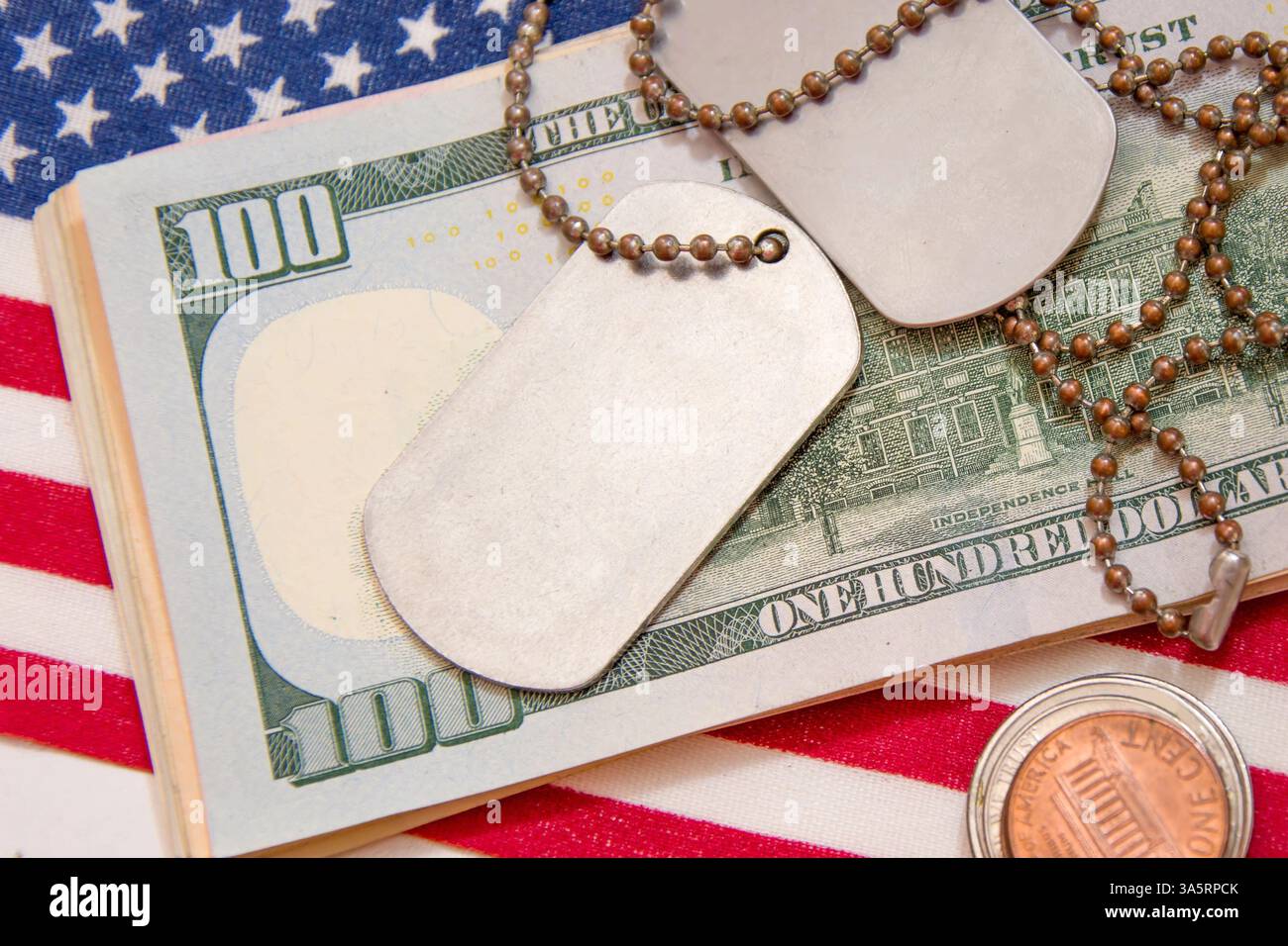 Vor dem Hintergrund der amerikanischen Flagge und der Dollarscheine liegen Armeemedaillons. Konzept: Militärrente, Gehalt in der Armee, Versicherung Stockfoto