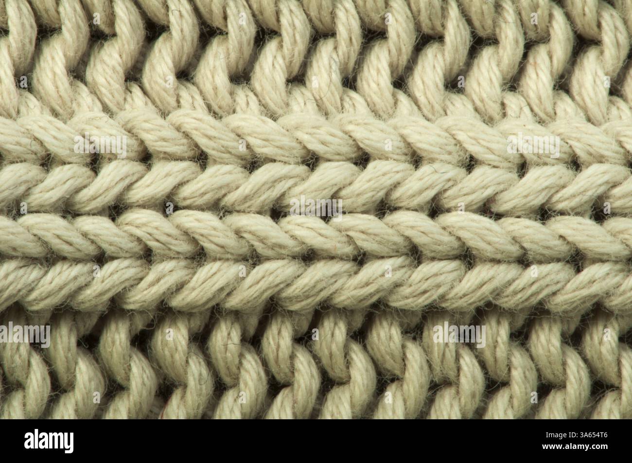 Alten Strickpullover Hintergrund. Beige Farbe. Studio gedreht Stockfoto