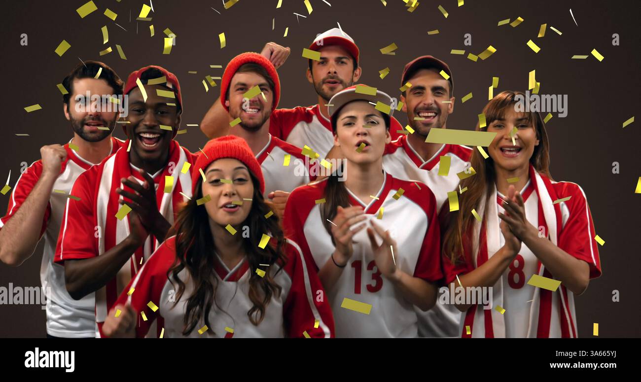 Bild eines Goldkonfetti, das über eine Gruppe männlicher und weiblicher Sportfans fällt Stockfoto
