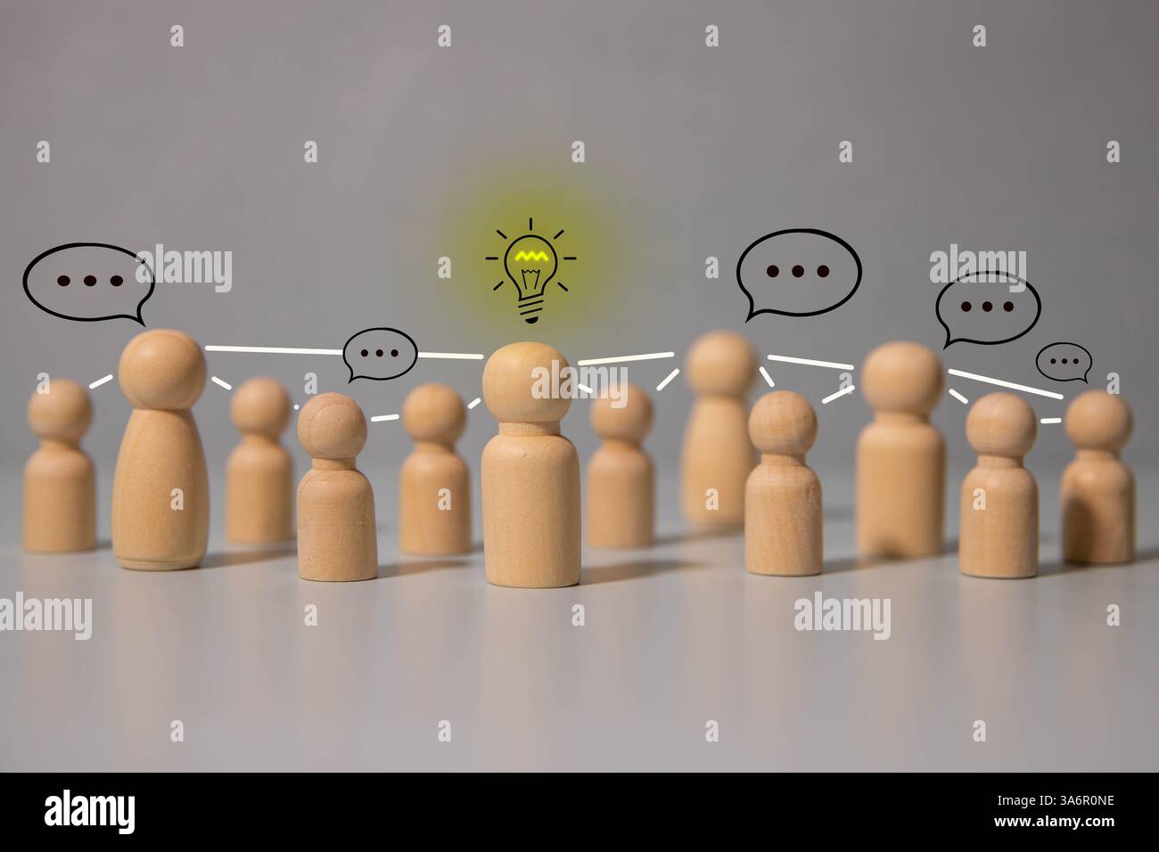 Holzfigur, die sich von der Menschenmenge abhebt, plauderndes Konzept, Holzfigur mit Sprechblase, einzigartige menschliche Form, Führung Stockfoto