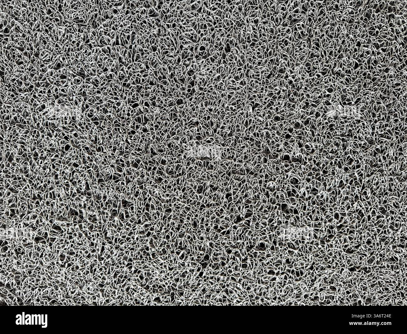 Nahaufnahme von grauen Büscheln mit Gummibodenmatte in zufälligem Muster. Nahtloser Teppichteppich oder matter Hintergrund in grauer Farbe. Geeignet für Vordertür. Stockfoto