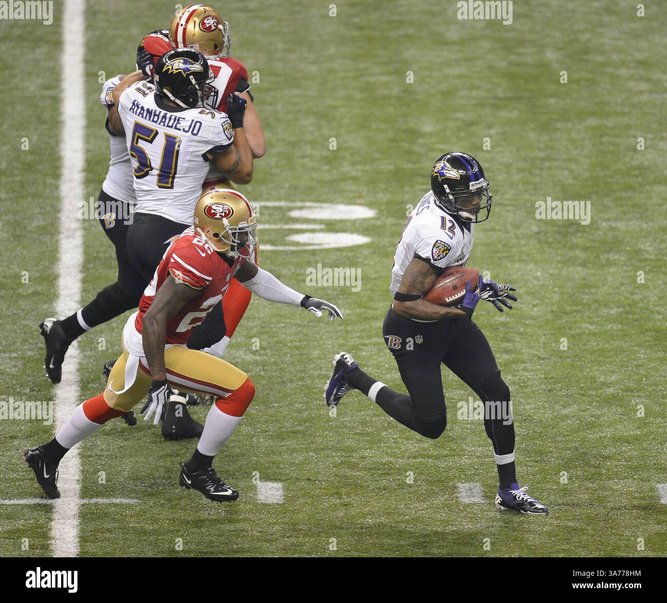 3. Februar 2013 – New Orleans, LA, USA – Jacoby Jones (12) von den Baltimore Ravens distanziert sich am Sonntag, den 3. Februar 2013, von Tramaine Brock (26) von den San Francisco 49ers. (Bild: © Harry E. Walker/MCT/ZUMAPRESS.com) Stockfoto