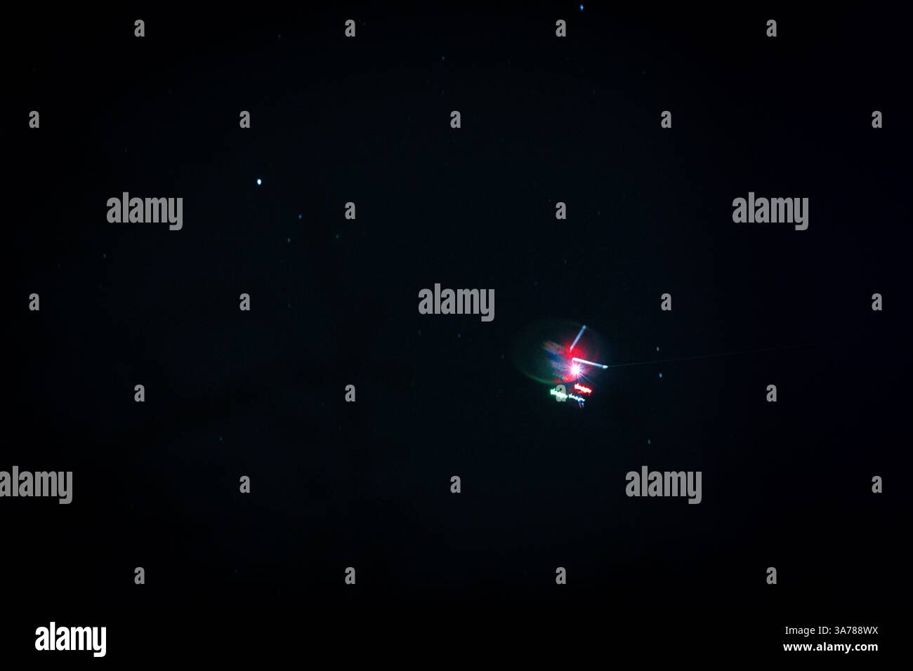 Geheimnisvolle UFO-Sichtung im Nachthimmel – unerklärliches Flugobjekt mit rotem und grünem Licht – unheimliches, unscharfes, abstraktes U.F.O.-Konzept Stockfoto