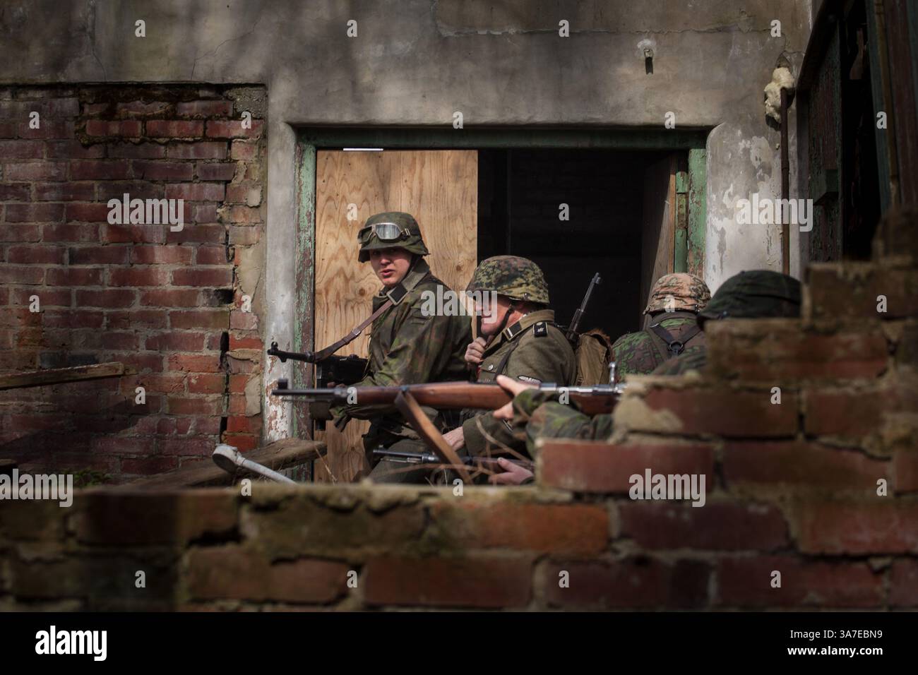 7. April 2013: Gosport Hampshire, England, Vereinigtes Königreich - Schauspieler stürmen ein Gebäude während der Veranstaltung Spirit of the 40 im Explosionsmuseum in Gosport Hampshire. Das Museum befindet sich im ehemaligen Rüstungsdepot der Royal Navy in Priddy's Hard. (Kreditbild: © Hanna Adcock/ZUMAPRESS.com) Stockfoto