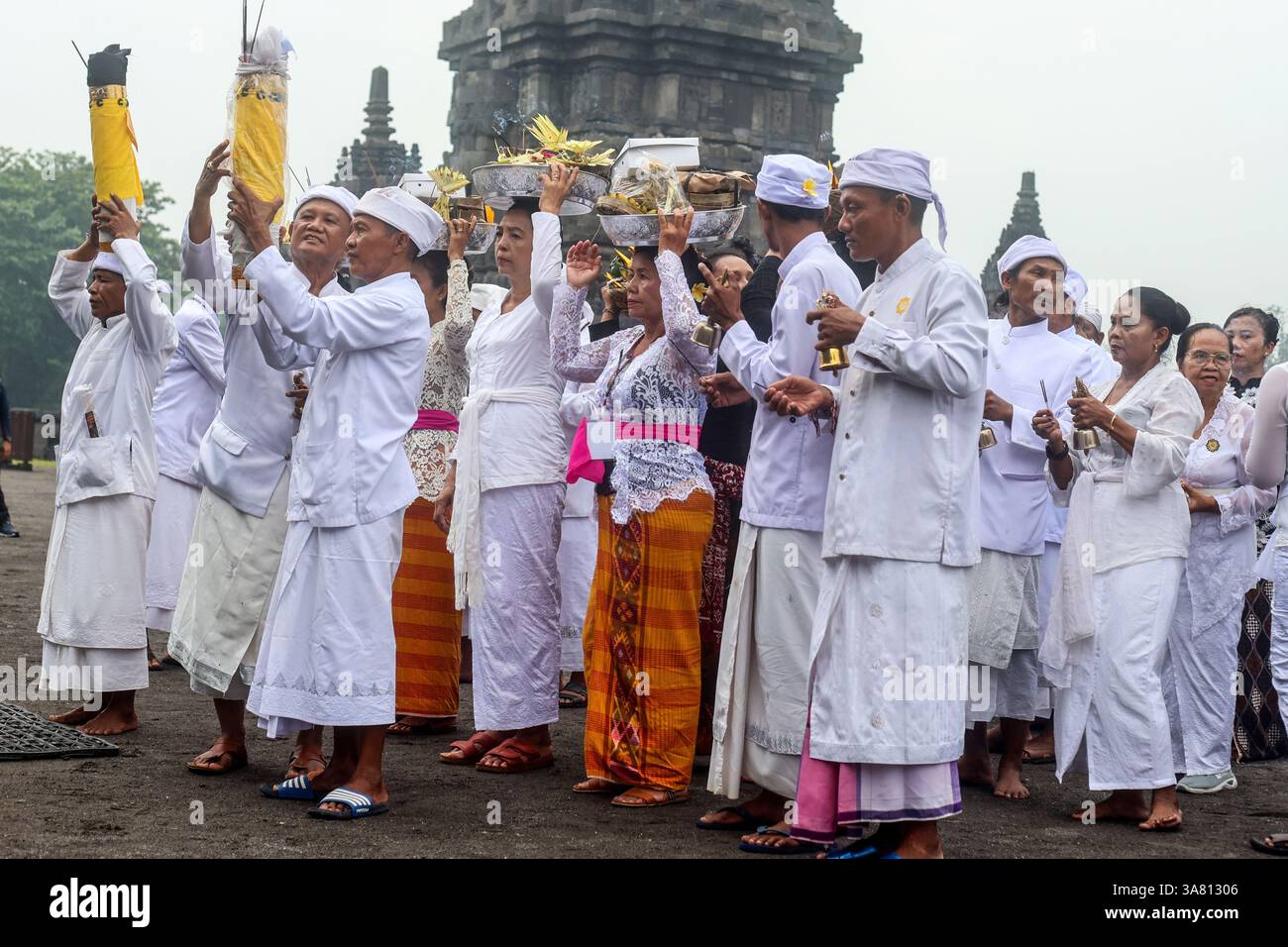 28. März 2025, Sleman, Yogyakarta Special Region, INDONESIEN: Hindus führen ein Gebetsritual durch, indem sie während der Pradaksina-Prozession während der Tawur Agung Kesanga-Zeremonie im Prambanan-Tempel in Sleman, Yogyakarta am 28. März 2025 Opfergaben bringen. Diese Zeremonie findet einen Tag vor dem Nyepi-Tag statt, an dem indonesische Hindus keine Aktivitäten wie Kochen, Essen, Trinken, Arbeiten und Reisen durchführen. Tawur Agung ist ein Reinigungsritual, um die Elemente Erde, Wasser, Feuer und Luft auszugleichen, und ist ein Moment der Selbstreflexion vor dem Eintritt in das Penyepian Catur Brata. (Bild: © Antonius Ja Stockfoto
