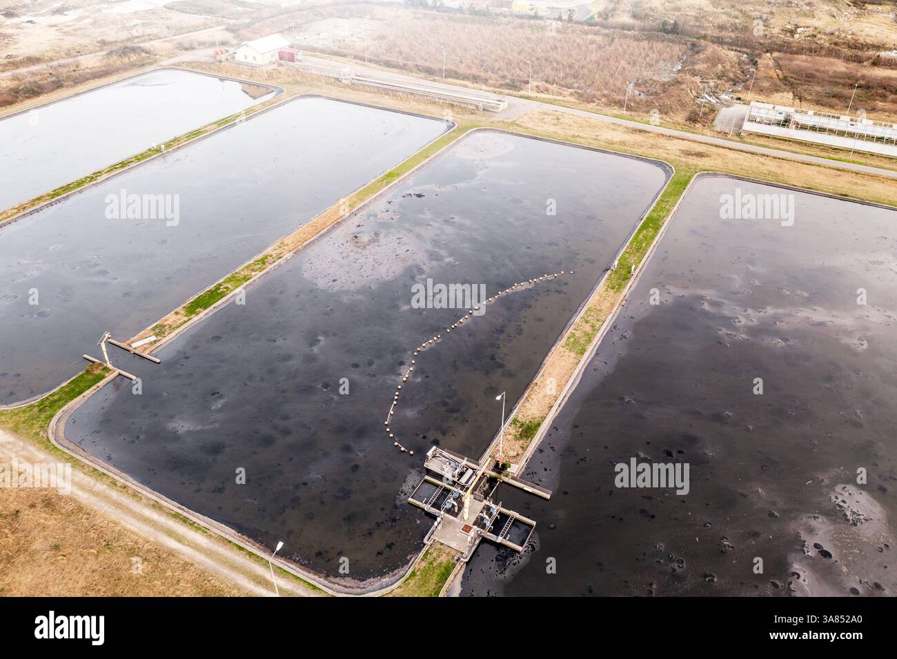 Abwasseraufbereitungsteiche mit Sedimentationsbecken aus der Vogelperspektive, Teil einer industriellen Wasseraufbereitungsanlage. Stockfoto