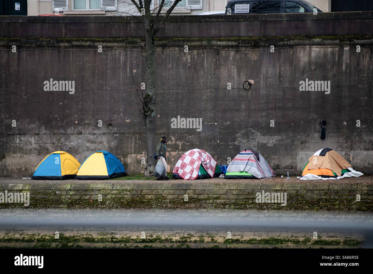 Paris, Frankreich. März 2025. Ein provisorisches Migrantenlager hat sich entlang der seine in Paris nach der Vertreibung der Bewohner aus dem Theater Gaîté Lyrique gebildet. Am 28. März 2025, in den frühen Morgenstunden, erließ die Pariser Polizeipräfektur einen förmlichen Evakuierungsbefehl für das Gelände. Die Operation steht noch aus, als Reaktion auf eine Berufung humanitärer Organisationen ein Gerichtsurteil ergangen ist. Paris, Frankreich am 28. März 2025. Foto: Florian Poitout/ABACAPRESS. COM Credit: Abaca Press/Alamy Live News Stockfoto